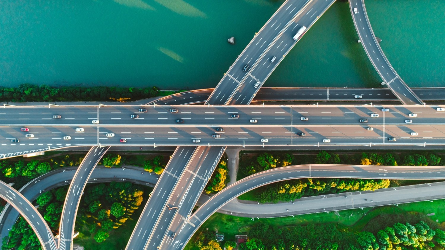 Aerial view of a modern logistics hub with automated sorting systems and highway infrastructure
